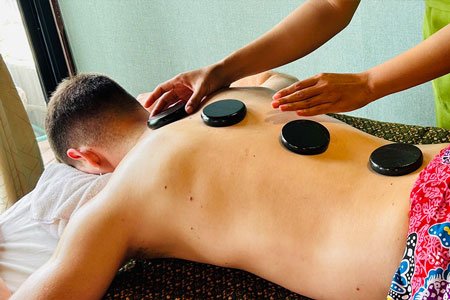 Anavana Massage & Welness Male Guest Receiving Invigorating Hot Stone Massage